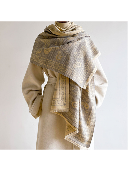 Light Gray paisley scarf wrapped and draped over a cream coat