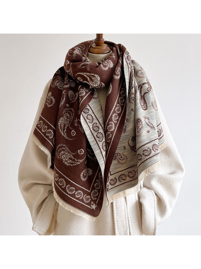 Brown paisley scarf looped at the neck with its contrasting reverse side visible