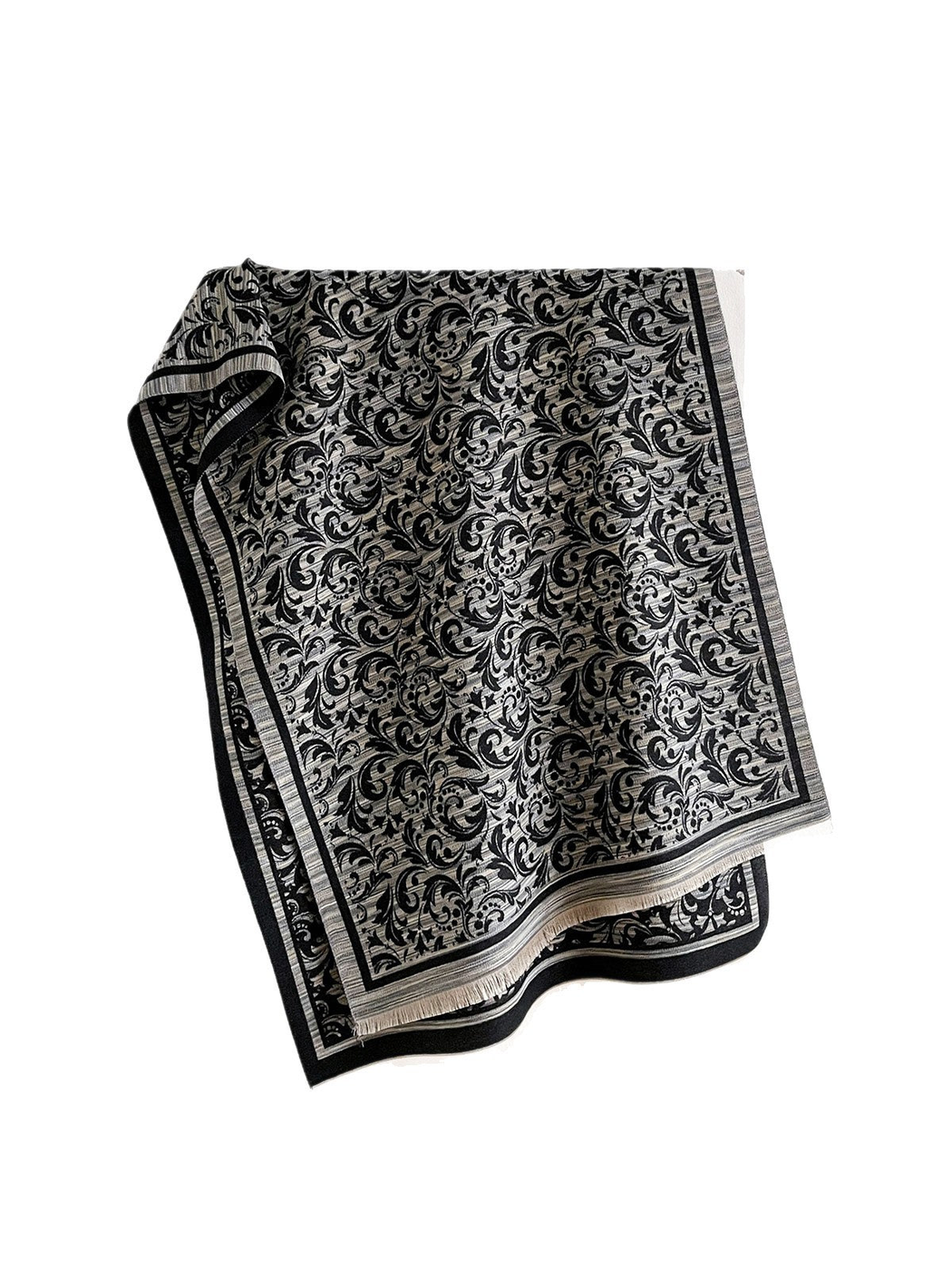 Black Gray scarf draped open on white, with scrolling leaves, a striped border and short fringe.