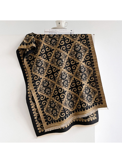Black / Gold scarf draped open with floral diamonds, bold ornamental scrolls and short fringed ends.