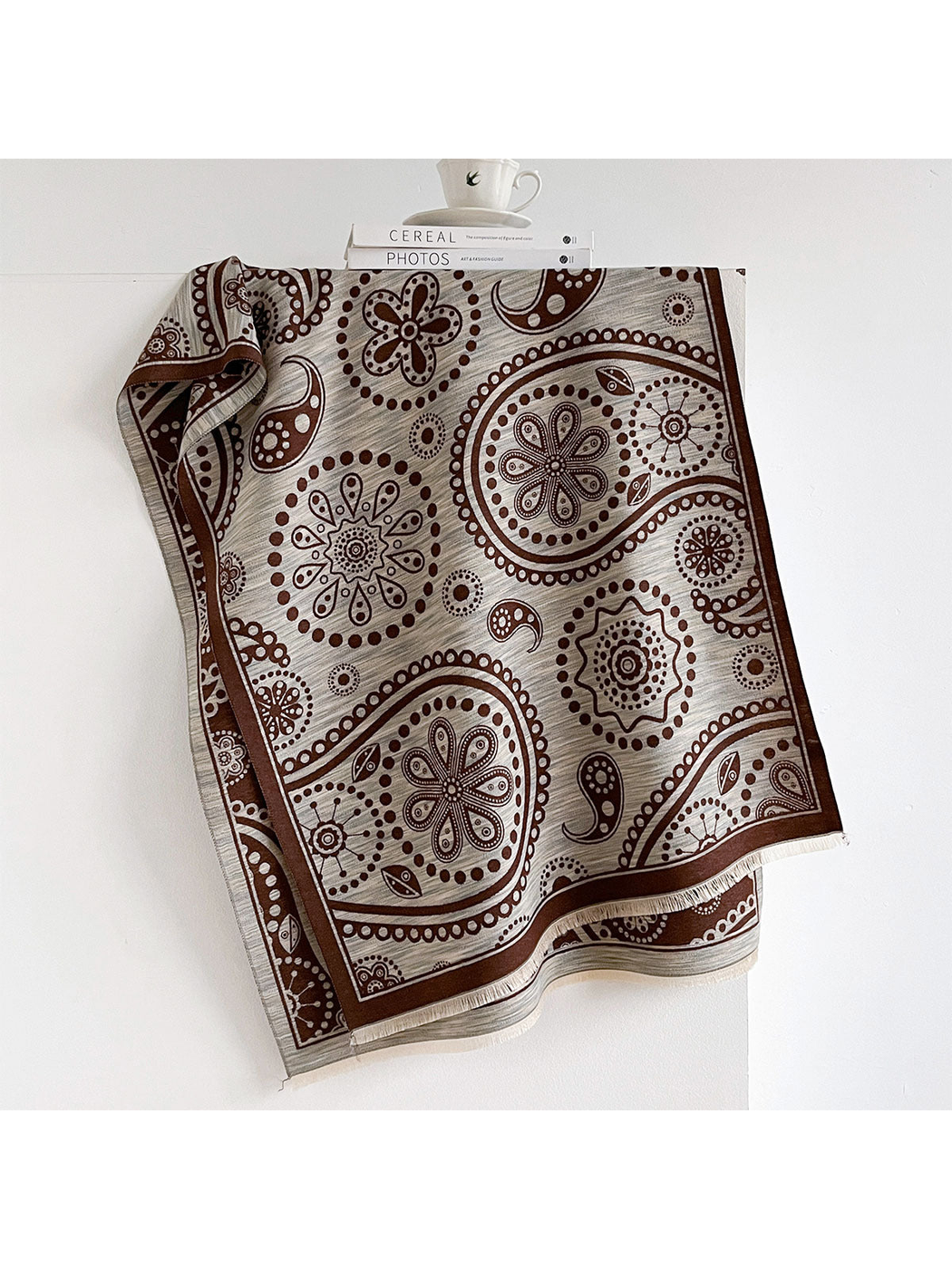 Coffee / Gray paisley scarf with floral medallions, a dark border and short fringe.