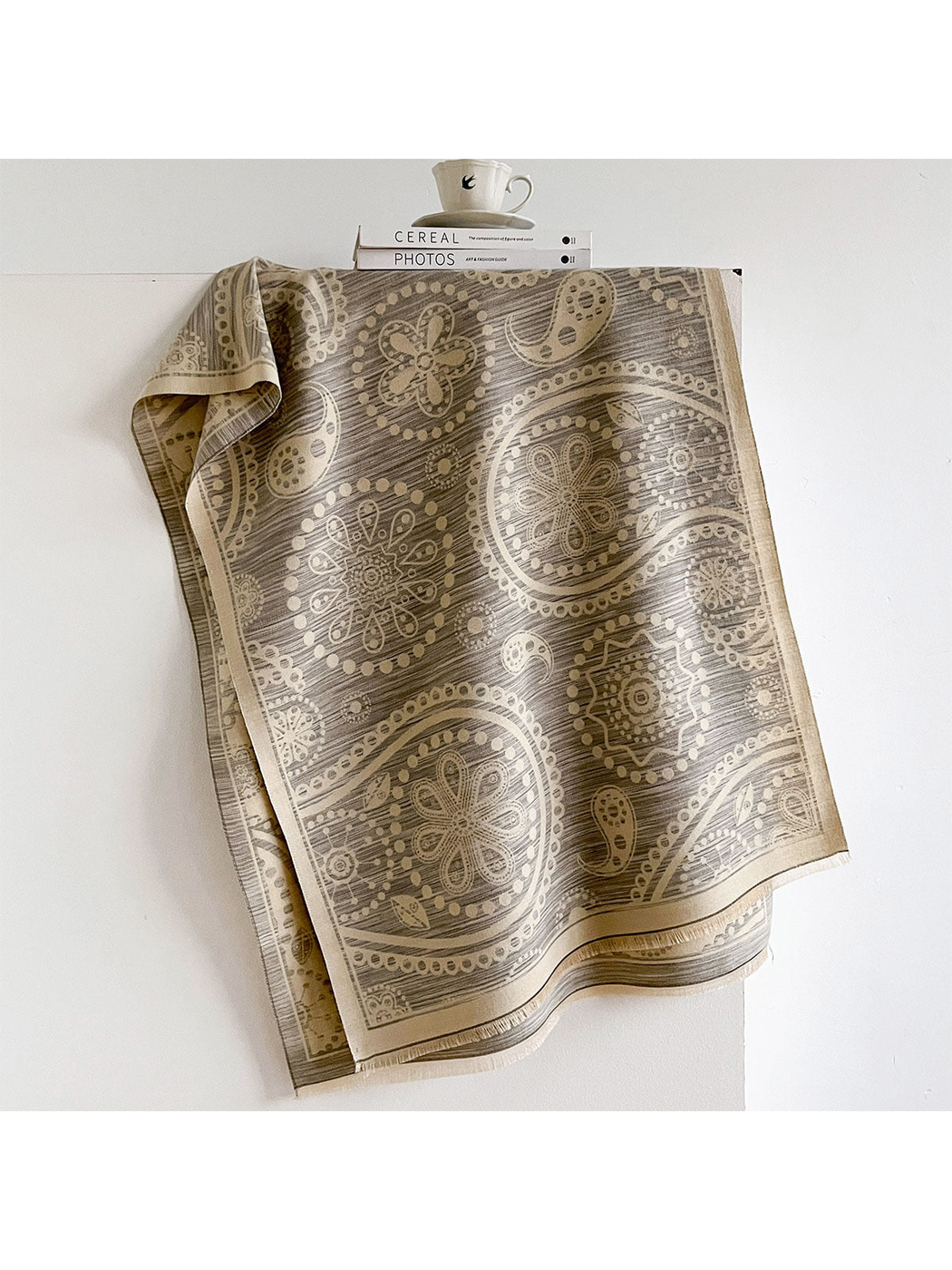 Gray / Ivory paisley scarf draped to show its floral medallions, pale border and short fringe.