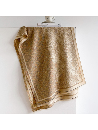 Multicolor scarf draped to reveal fine stripes, a paisley panel and fringed edges.