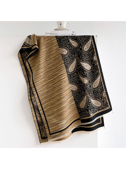 Black / Gold scarf with fine stripes, a contrasting paisley panel and short fringe.