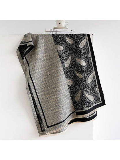 Black Gray scarf with fine stripes beside a black paisley panel, contrasting borders and short fringe.