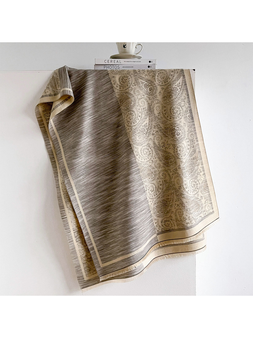 Gray / Cream scarf draped to reveal fine stripes, a cream paisley panel and fringed borders.