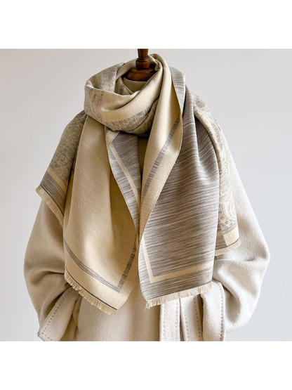 Gray / Cream scarf looped around a mannequin over a cream coat, revealing a broad cream underside and striped hanging end.