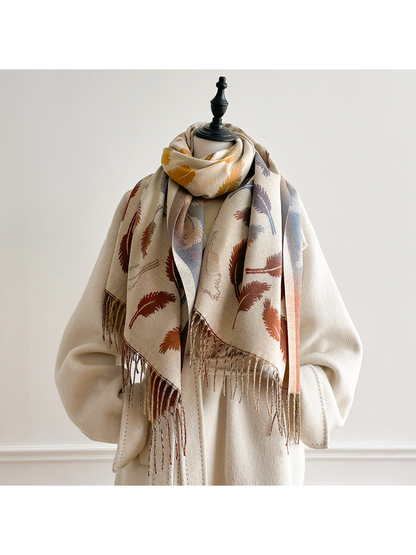 Cream feather-pattern scarf looped around a mannequin's neck, with both fringed ends hanging down the front.