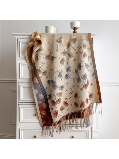 Ivory floral scarf draped over a white chest, with contrasting borders and long fringe.