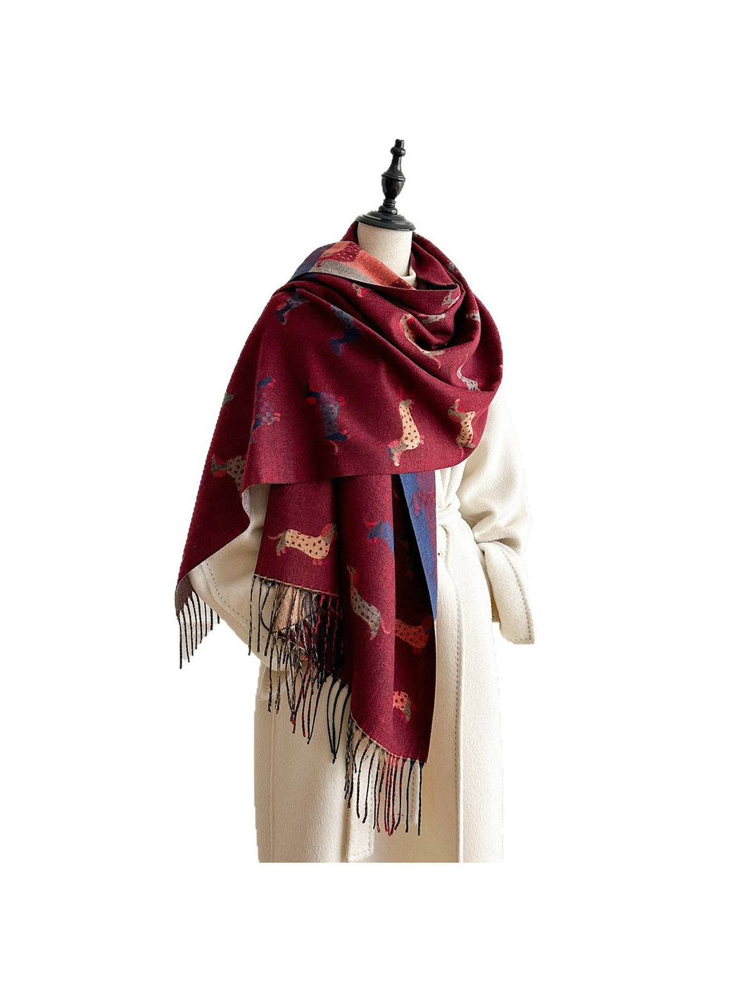 Burgundy dachshund-pattern scarf wrapped around a mannequin's shoulders, with long fringed ends against a white background.