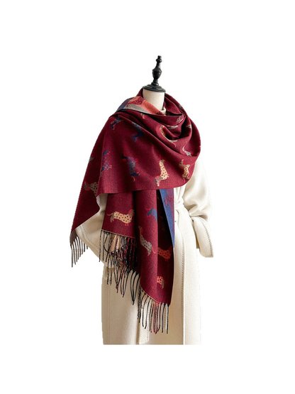 Burgundy dachshund-pattern scarf wrapped around a mannequin's shoulders, with long fringed ends against a white background.