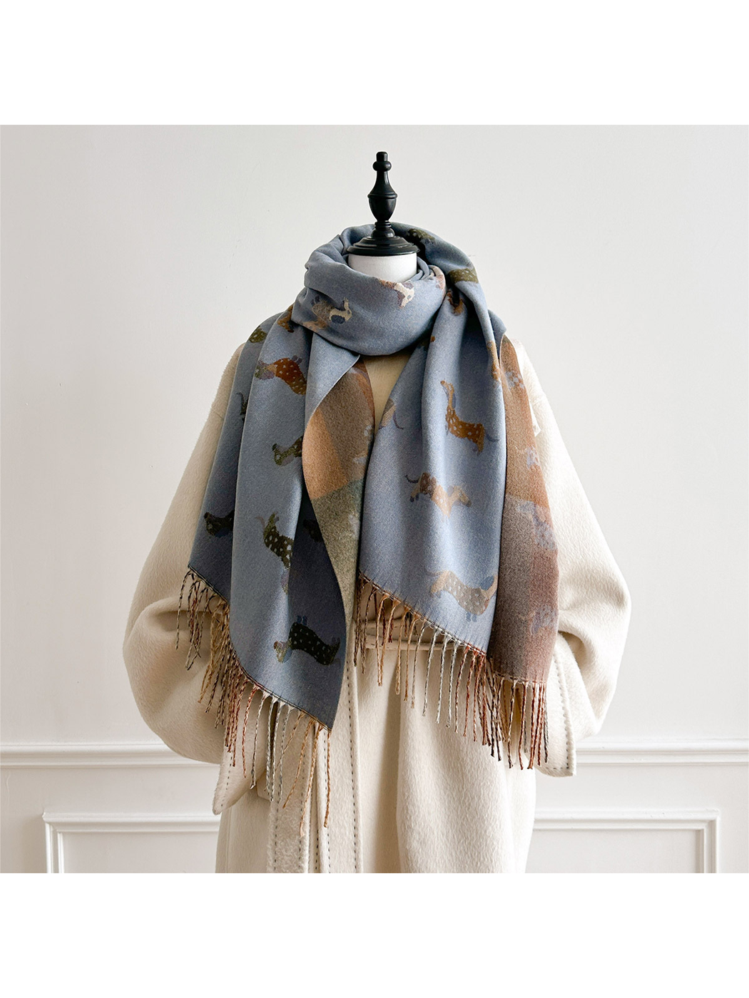 Blue Gray dachshund-pattern scarf looped around a mannequin's neck, with both fringed ends hanging in front.