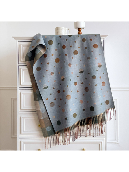 Blue Gray polka dot scarf draped over a cabinet, showing the color block reverse and fringed ends.
