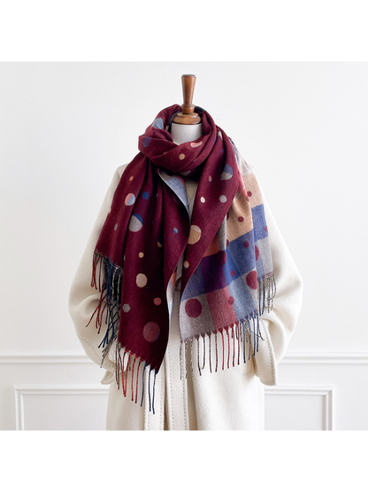 Burgundy scarf looped around a mannequin's neck, with polka dot and color block sides hanging in front.