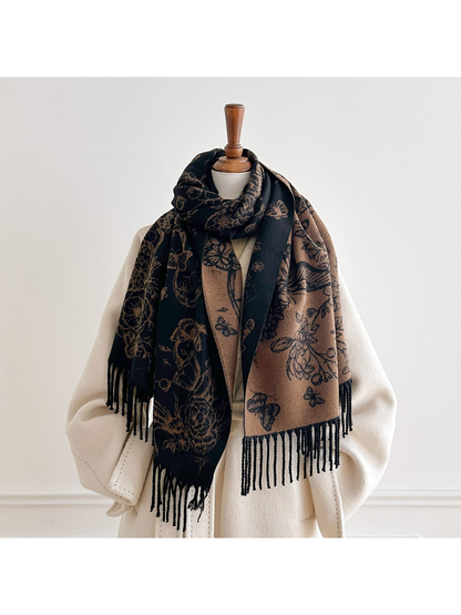 Black / Coffee floral and butterfly scarf looped around a mannequin's neck, with both contrasting sides hanging over a cream coat.