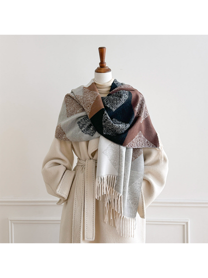 Light Gray paisley scarf wrapped across a mannequin's shoulders, revealing contrasting color blocks and hanging fringe.