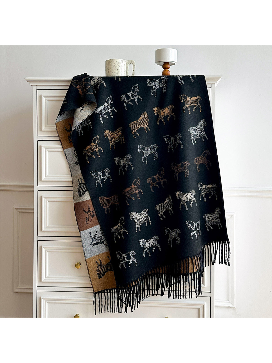 Black horse motif scarf draped over a dresser, with a contrasting color block reverse and long fringe.