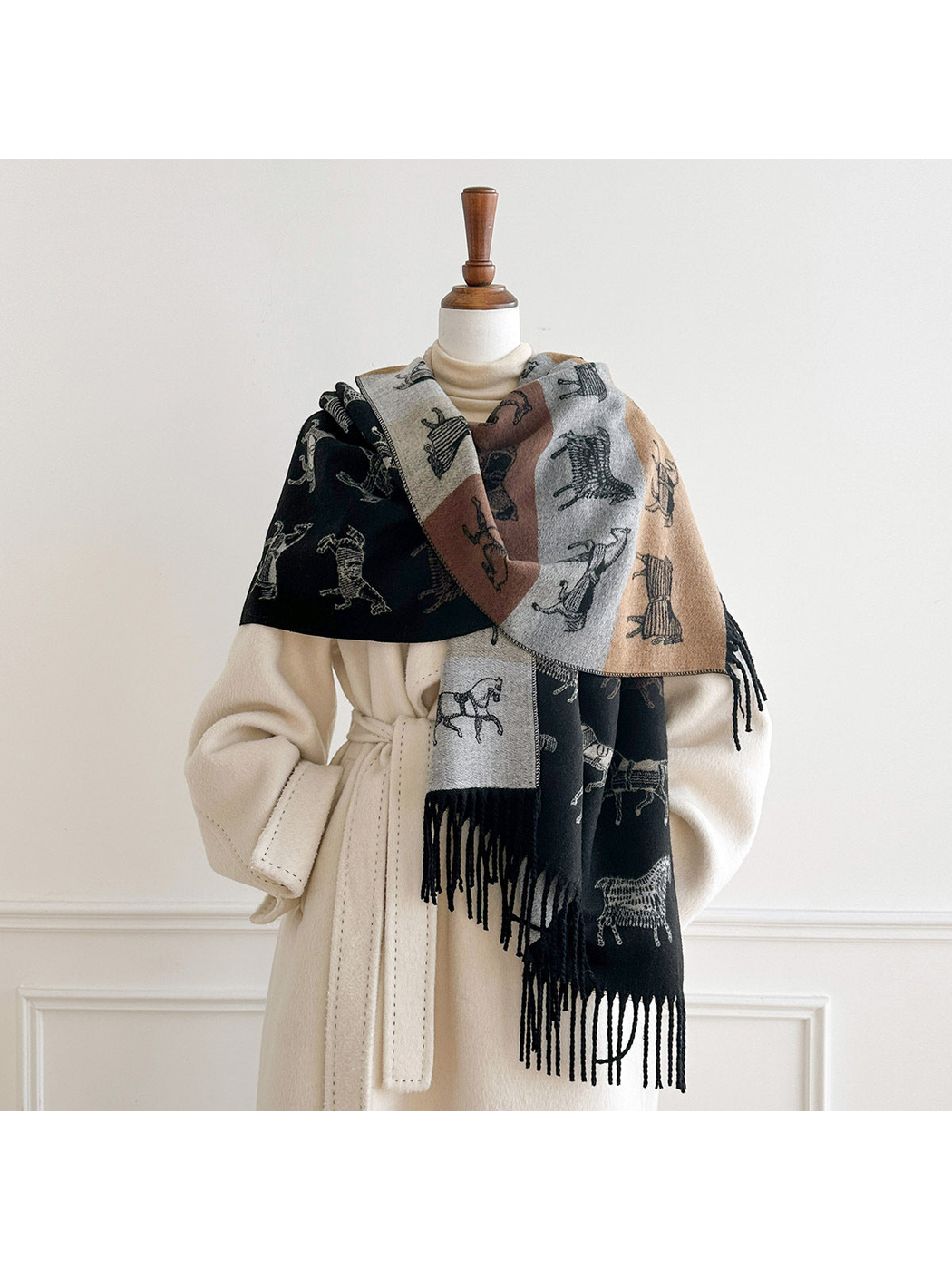 Black horse motif scarf wrapped across a mannequin's shoulders with the color block reverse facing outward.