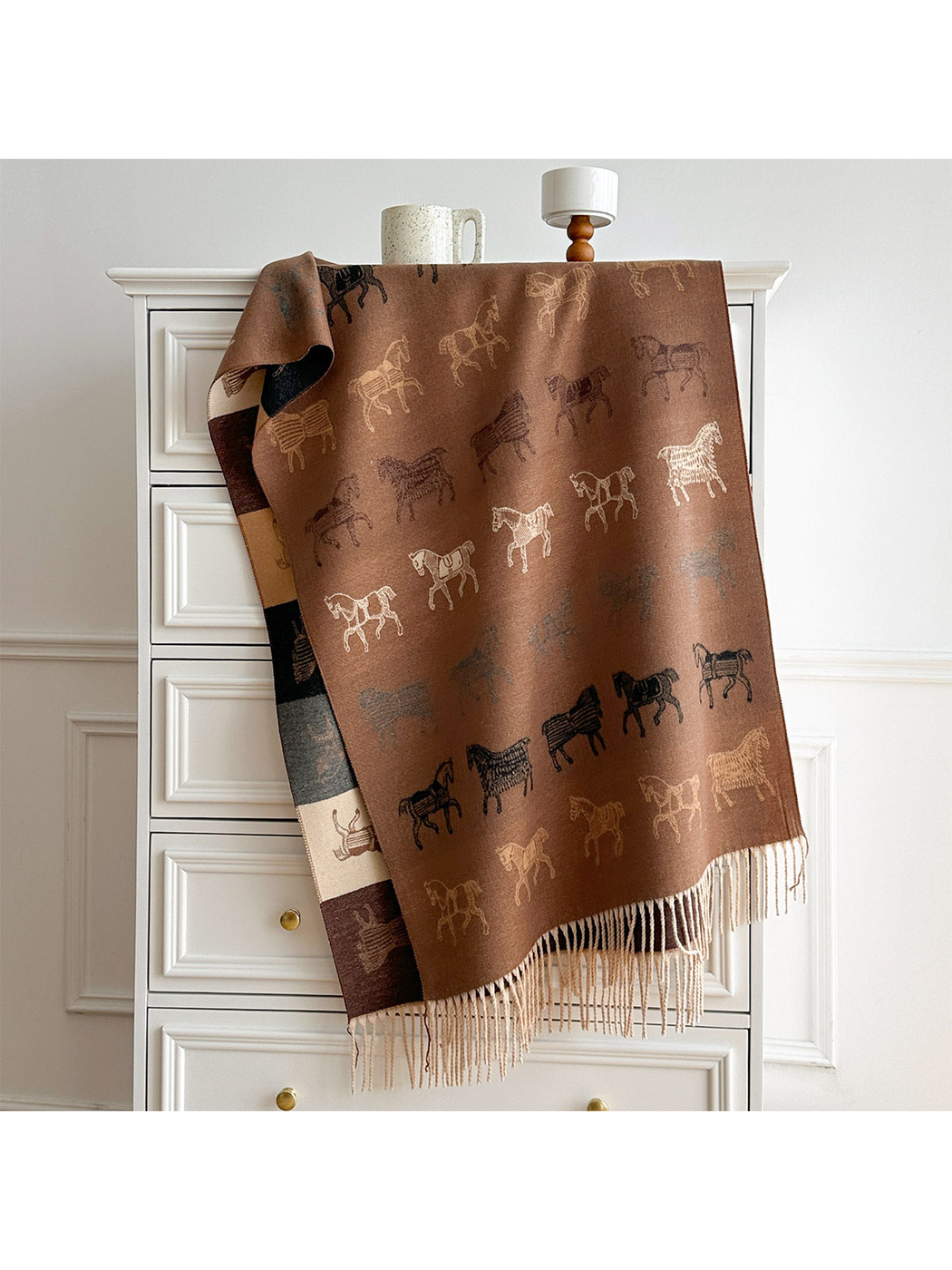 Brown horse motif scarf draped over a dresser, with a contrasting color block reverse and pale fringe.