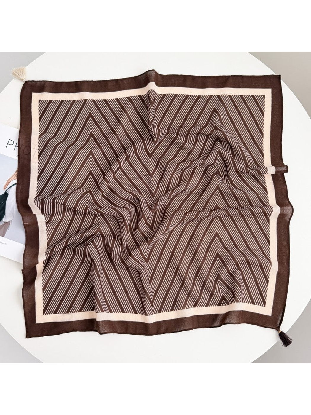 Dark Brown square scarf spread out with fine cream chevrons, a contrasting border and corner tassels.