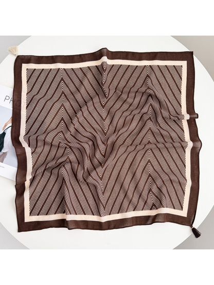 Dark Brown square scarf spread out with fine cream chevrons, a contrasting border and corner tassels.
