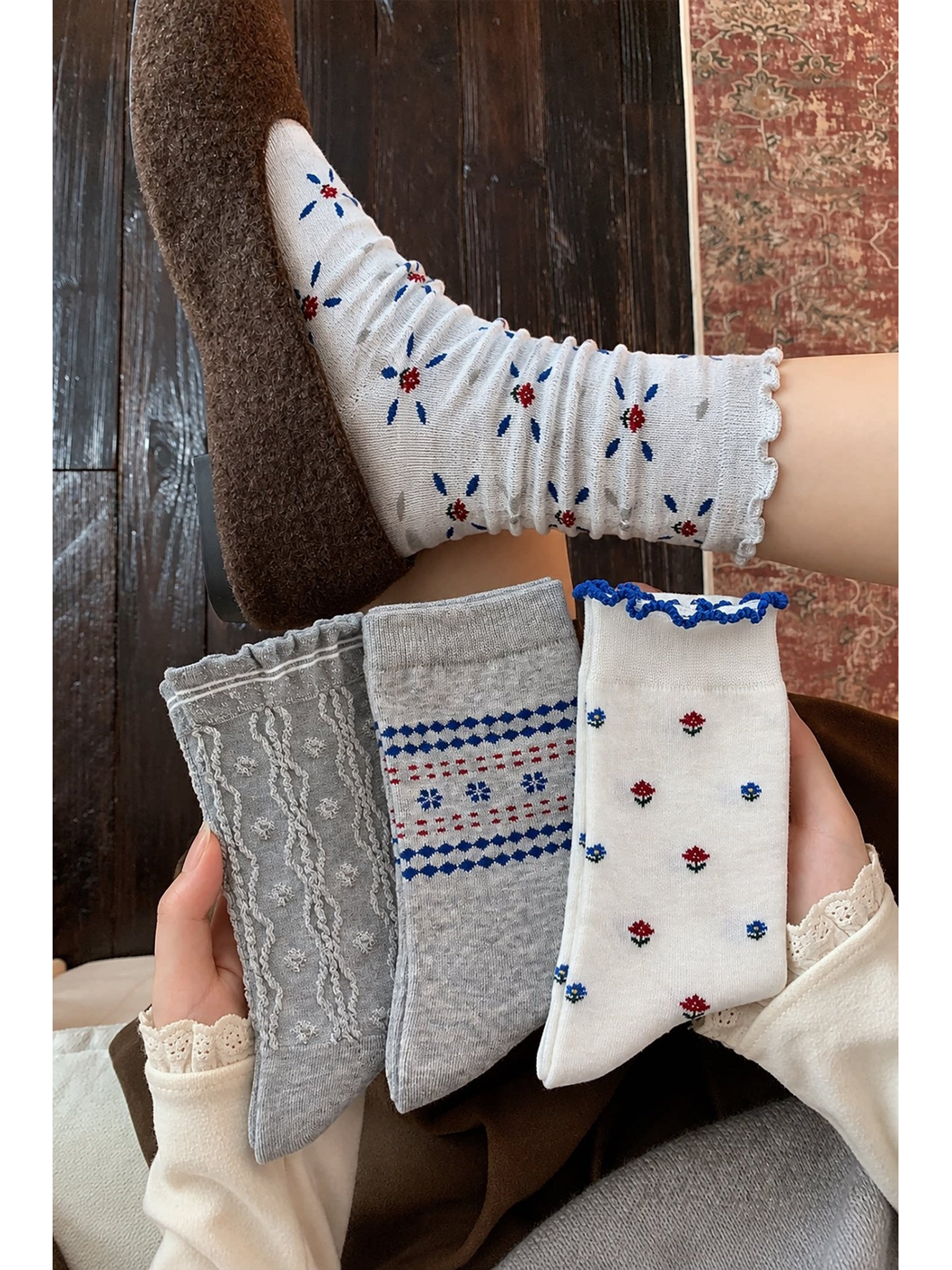 Floral, Petal Flowers, Wavy Stripes, and Geometric Flowers socks held together, with one sock worn in a brown shoe.