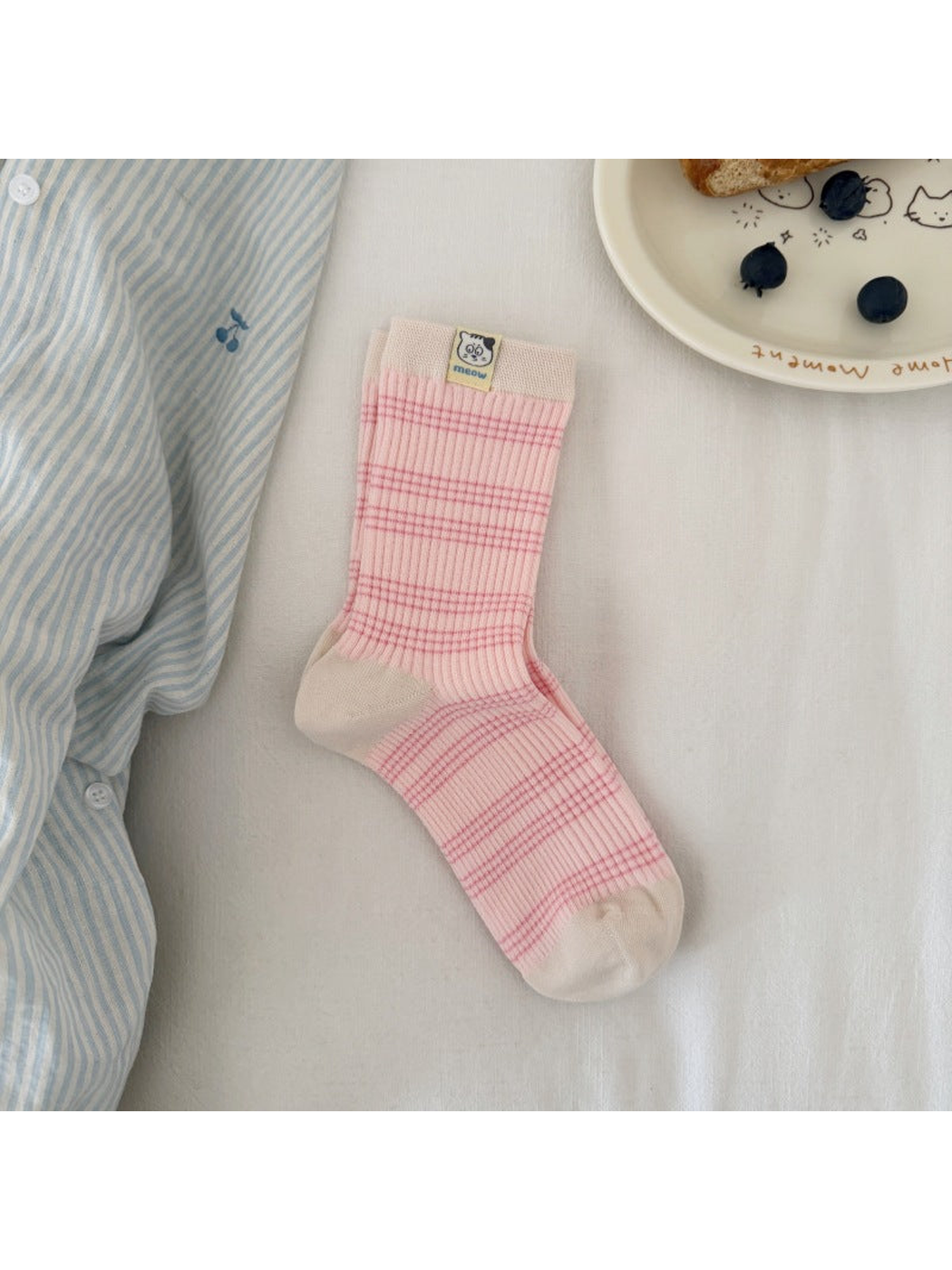 Pink / Ivory striped ribbed sock laid flat, showing contrasting cuff, heel and toe panels and a cat label.