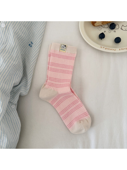 Pink / Ivory striped ribbed sock laid flat, showing contrasting cuff, heel and toe panels and a cat label.