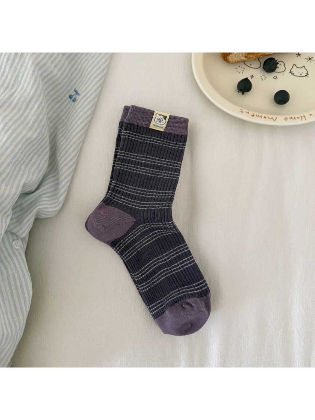 Navy / Purple striped ribbed sock laid flat, showing contrasting cuff, heel and toe panels and a cat label.