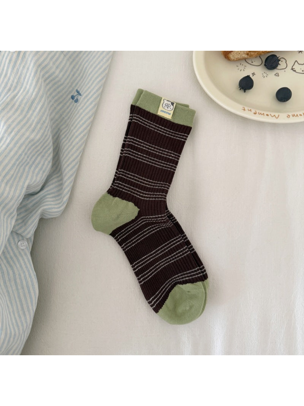 Brown / Green striped ribbed socks laid flat with contrasting cuff, heel and toe panels and a cat label.