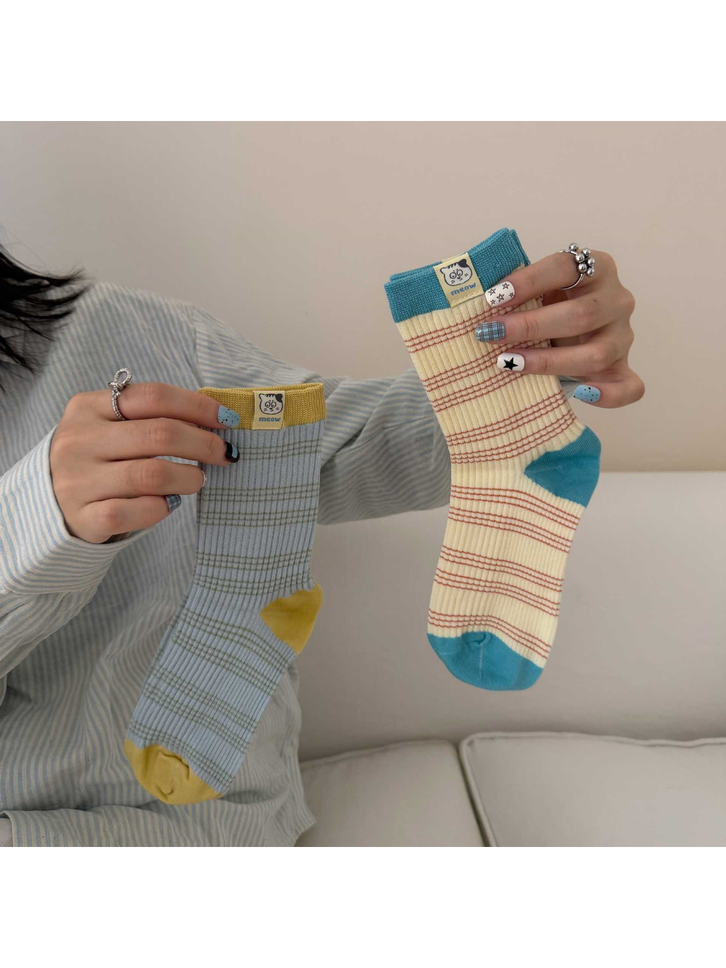 Blue / Yellow and Cream / Turquoise striped socks held upright, showing their ribbing and contrasting heel and toe panels.