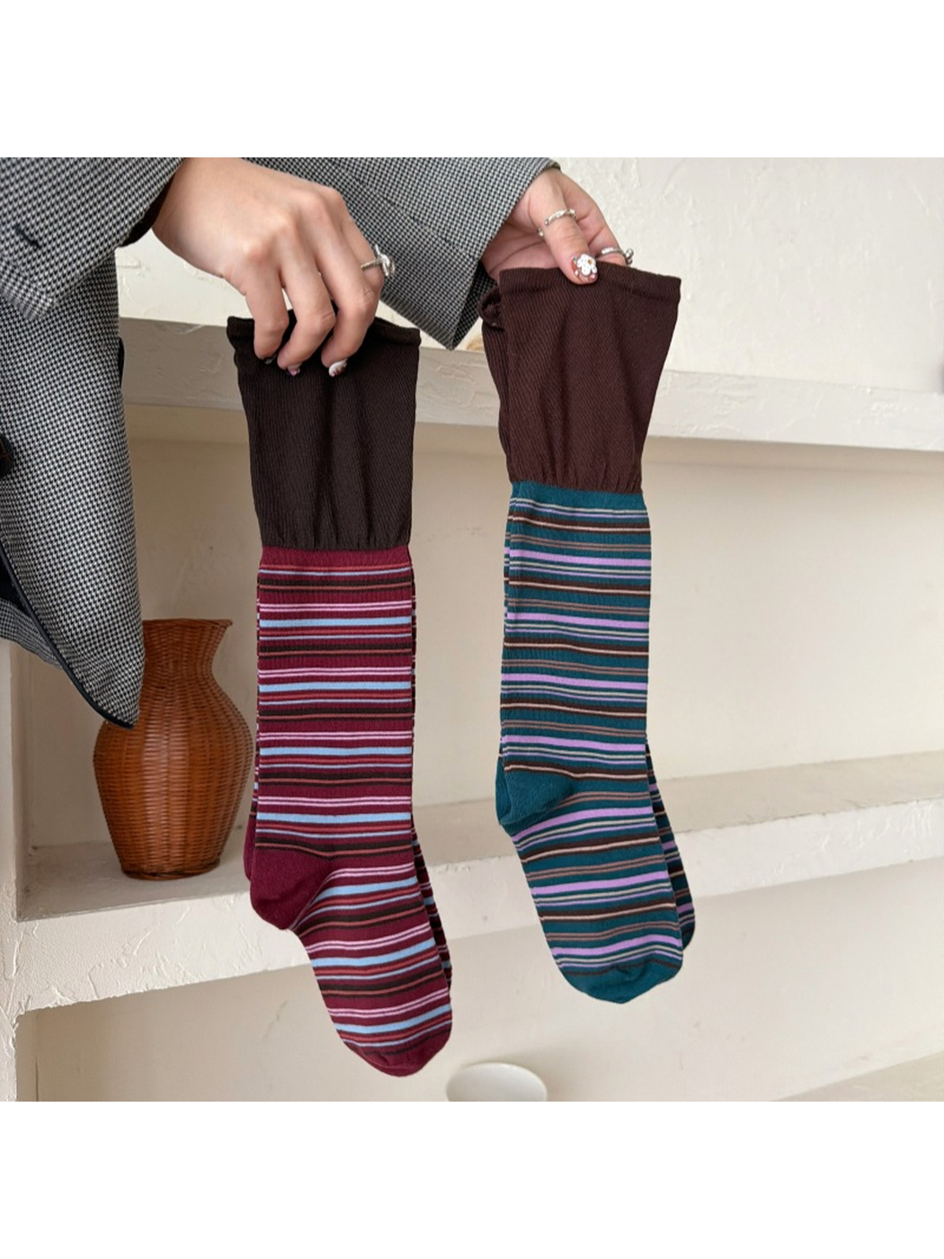 Burgundy and Deep Teal striped socks held upright side by side, showing broad brown cuffs, shaped heels and closed toes.