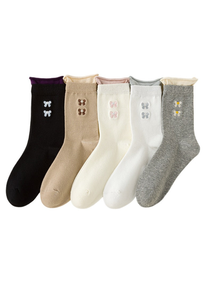Black, Beige, Ivory, White, and Heather Gray crew socks with contrasting rolled cuffs and embroidered bow motifs.