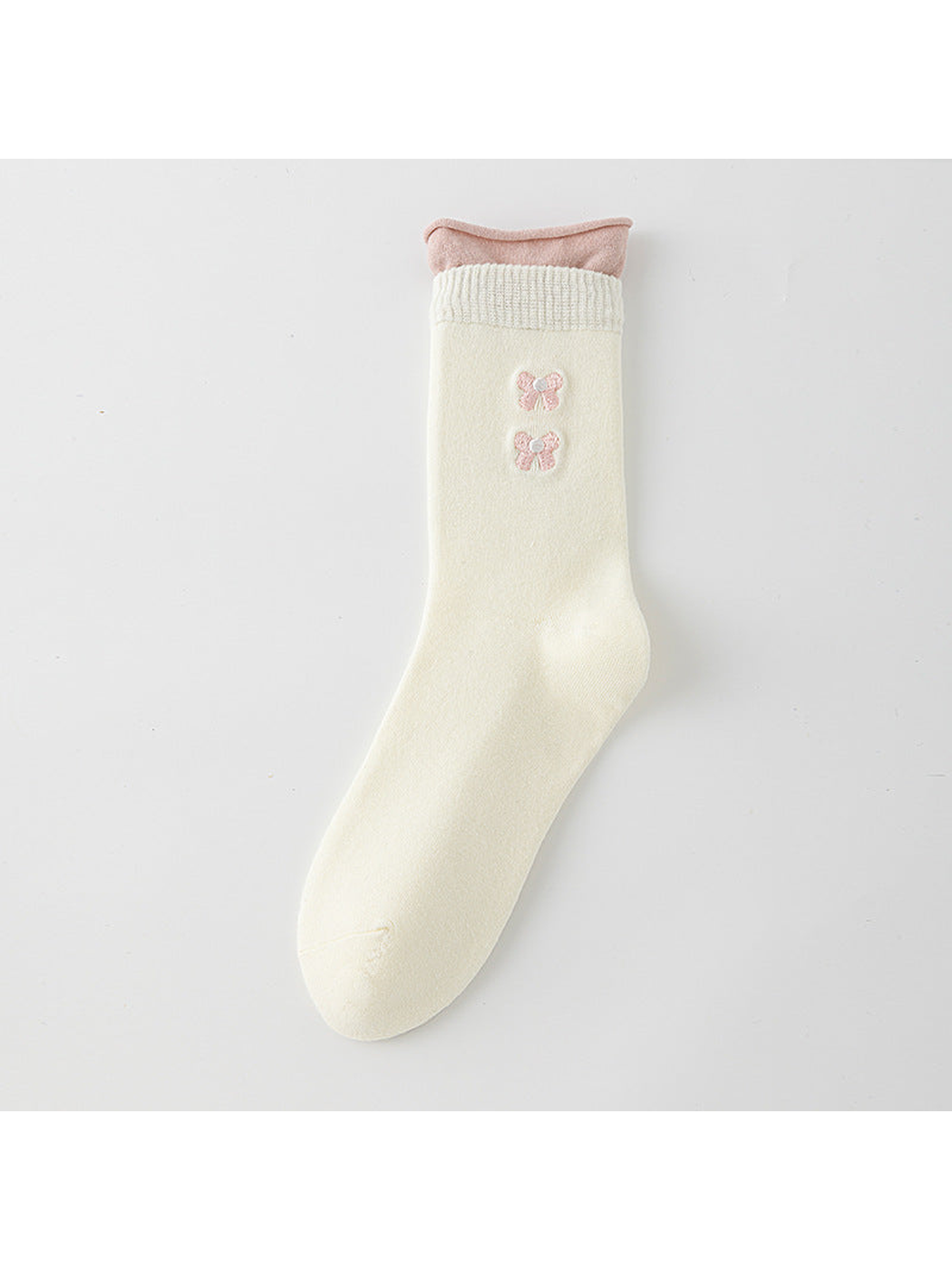 Ivory crew sock with a pink rolled upper edge and two pink bow motifs.