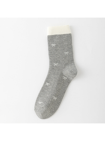 Light Gray ribbed crew sock with ivory cuff and small pale bow motifs.
