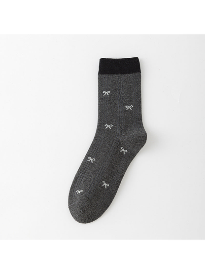 Dark Gray ribbed crew sock with black cuff and small pale bow motifs.