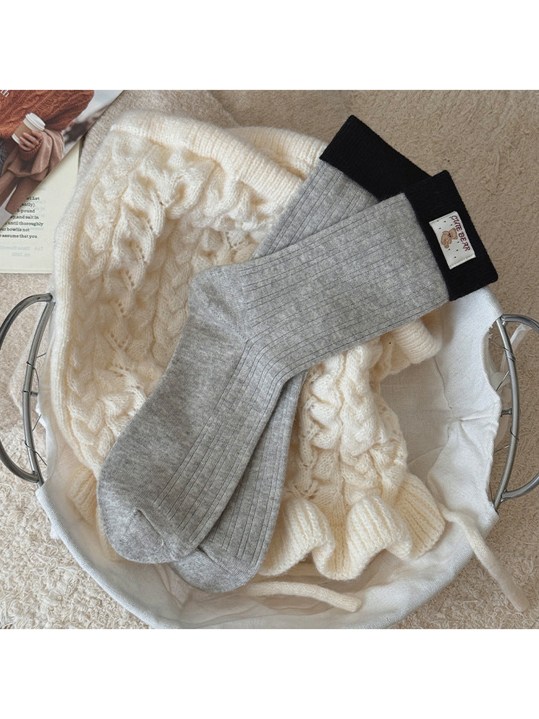 Light Gray ribbed socks with black folded cuffs and a bear label, laid flat.