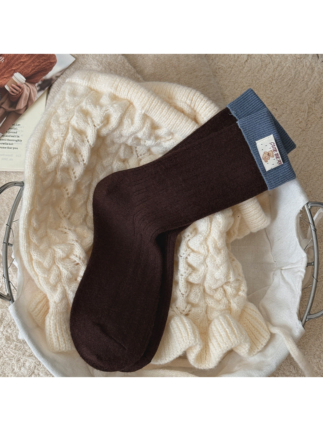 Dark Brown ribbed socks with blue folded cuffs and a bear label, laid flat.