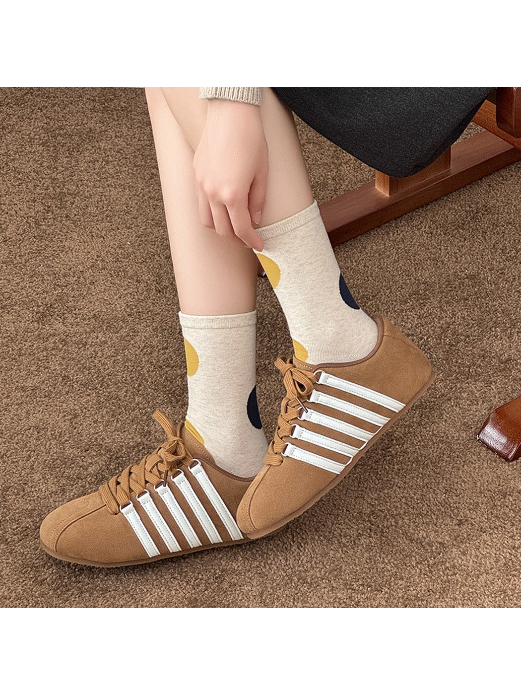 Beige socks with mustard and navy dots worn with tan lace-up shoes.