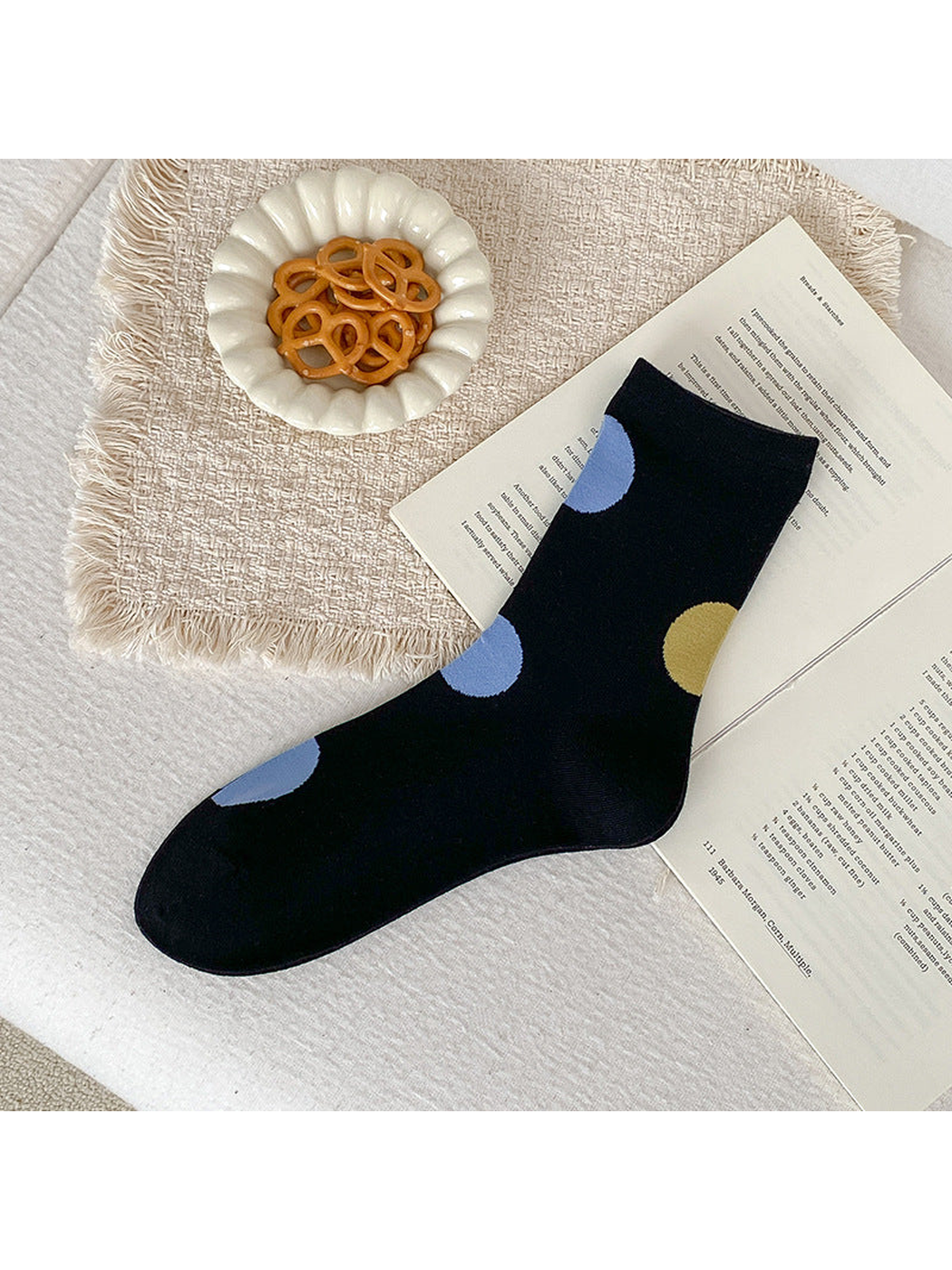 Black crew sock with oversized light blue and mustard yellow dots.