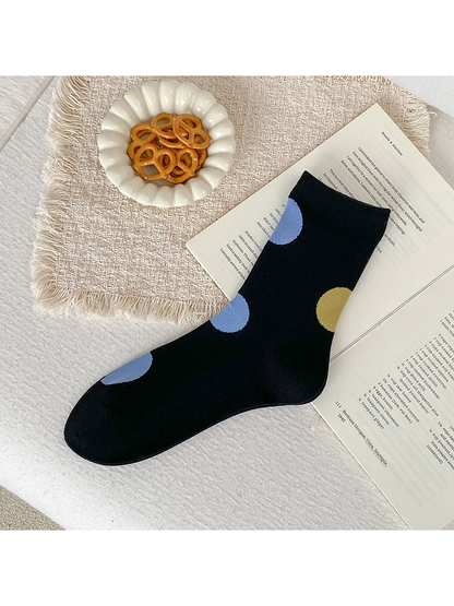 Black crew sock with oversized light blue and mustard yellow dots.