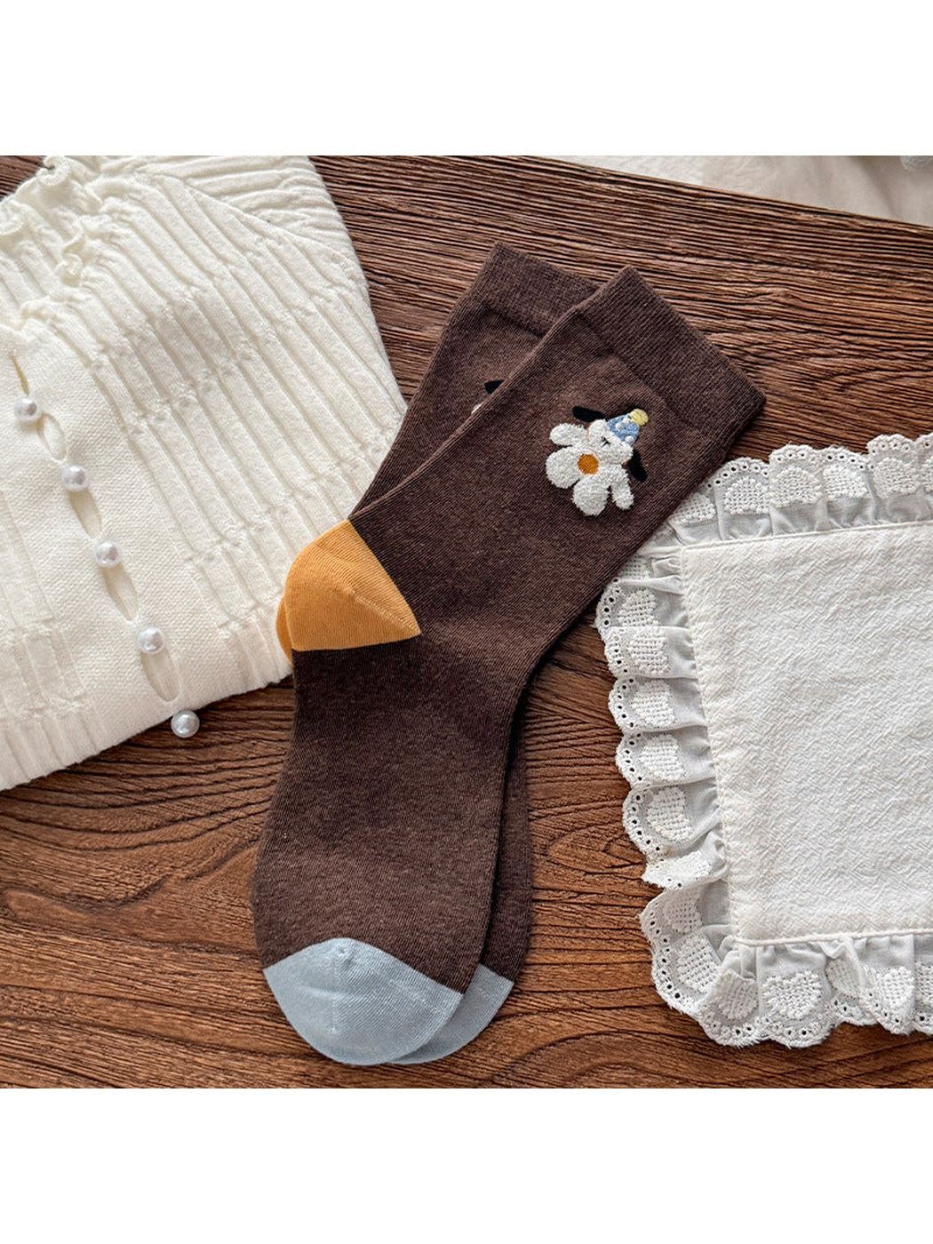 Multicolor crew socks with dog motifs, brown legs, yellow heels and pale blue toes