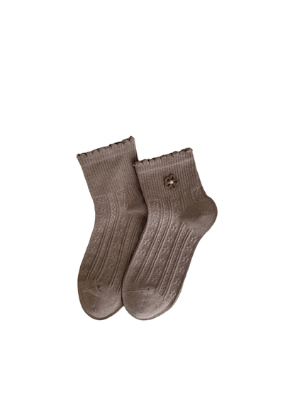 Coffee socks with brown flower appliqué, ruffled cuffs and vertical textured panels.