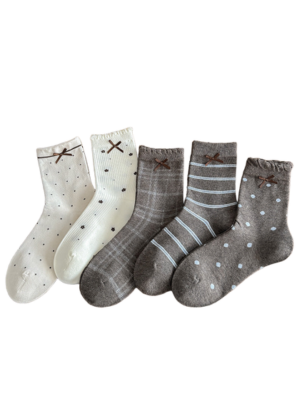Bow cuff socks in plaid, large dots, stripes, small dots, and floral patterns displayed together.