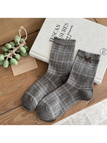 Plaid socks in heather gray with fine check lines and a brown cuff bow.