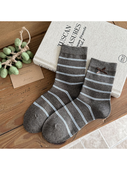 Stripes socks in gray with light blue horizontal lines and a brown cuff bow.