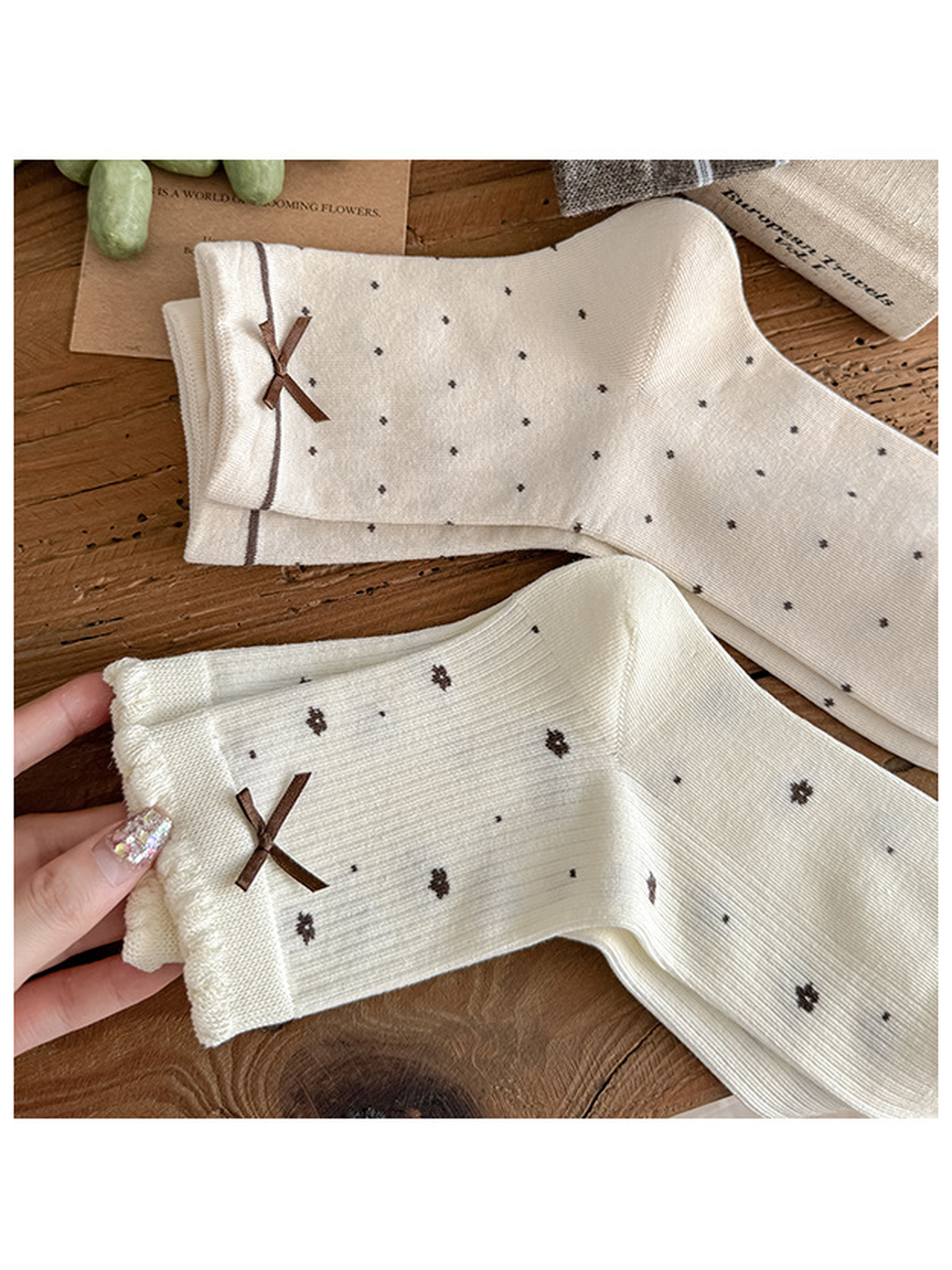 Close-up comparing small-dot and floral socks with brown bows and different cuff edges.