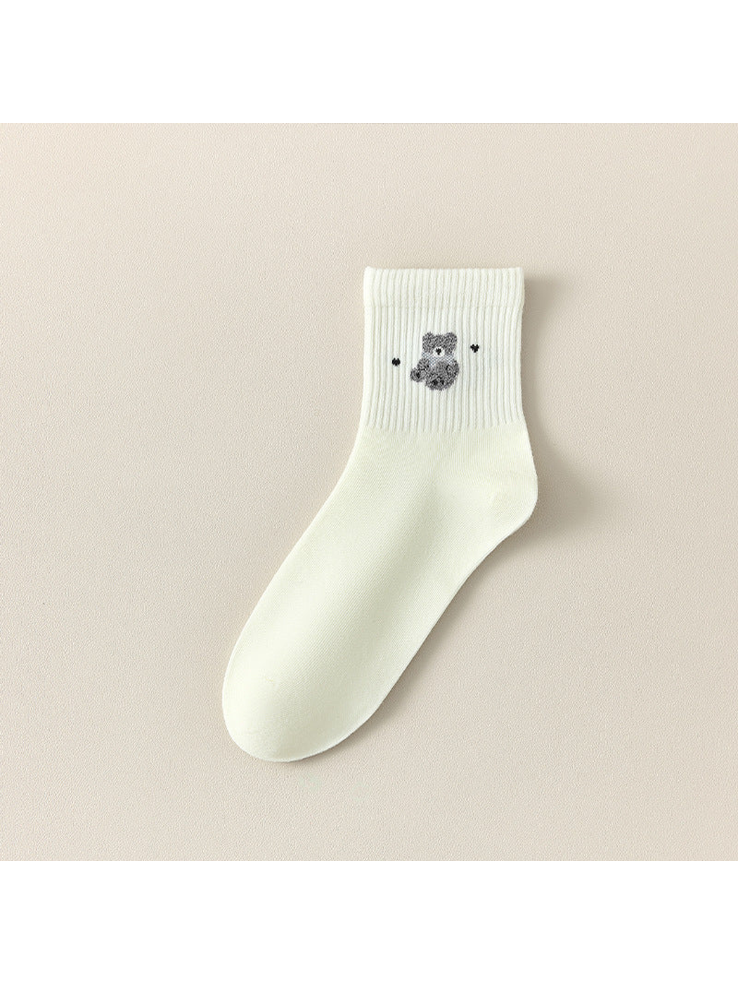 Ivory Bear crew sock with a gray bear motif between small dark accents.