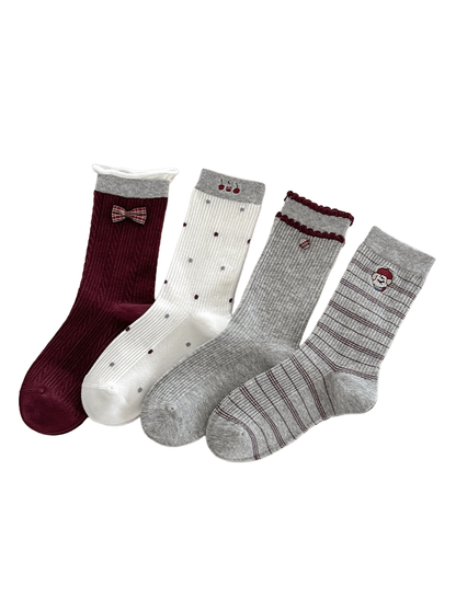 Burgundy bow, white polka dot, gray ruffle and gray striped socks displayed together.
