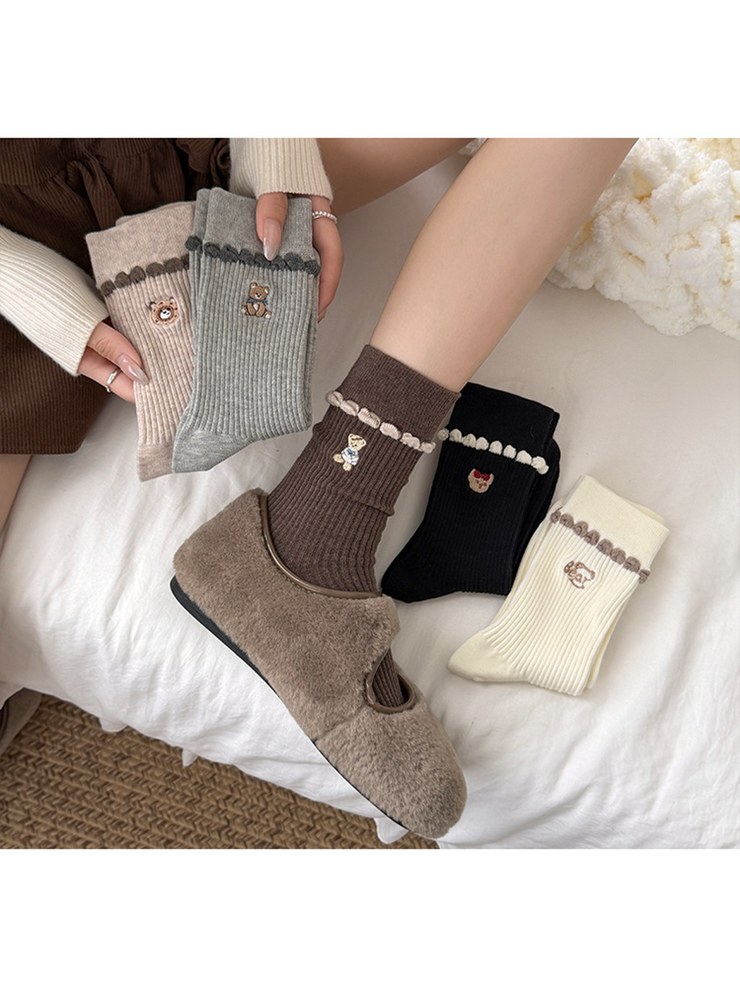 Coffee sock worn with a buckle shoe while hands hold Beige and Gray socks beside Black and Ivory socks.